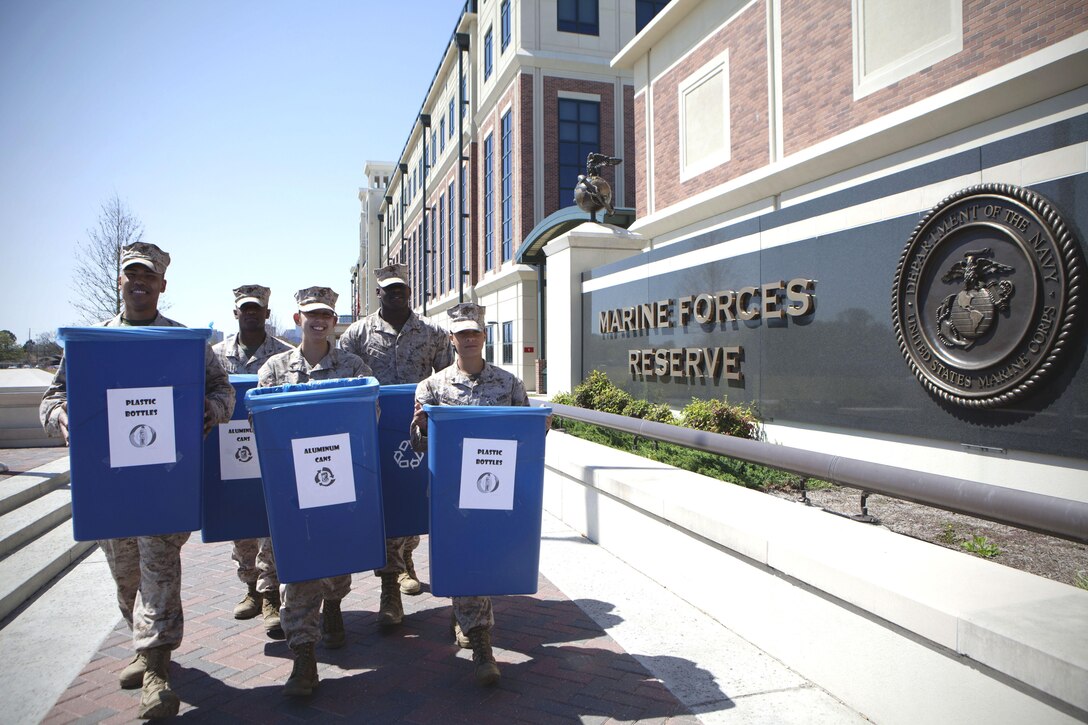 Marines from Installation Personnel Administration Center, Marine Corps Support Facility New Orleans, take out the recycling bins to the trash container, March 25, 2013. A new recycling initiative is being introduced to the 1,200 Marine and civilian personnel that man the facility in order to recycle items such as paper, cardboard, plastic, aluminum, tin and steel cans.  