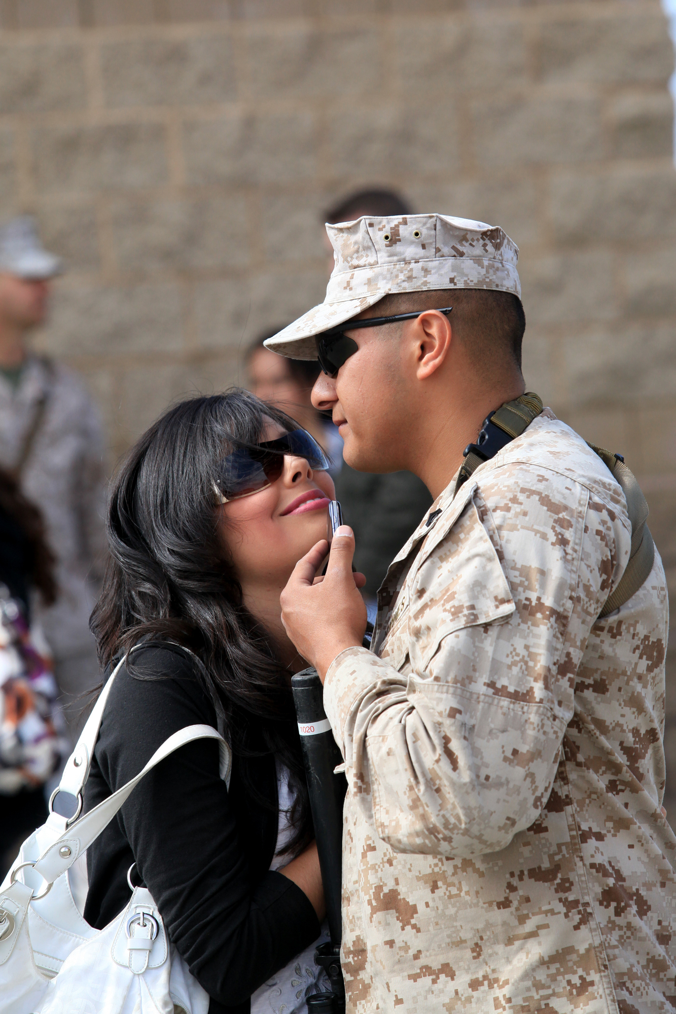 Cpl. Daniel Ortiz (left), a warehouse clerk with Georgian Liaison Team 8, from Fresno, Calif., says goodbye to his wife Emma as he prepares to depart for a seven-month deployment to Afghanistan at Camp Pendleton, Calif., March 22. During their deployment, members from GLT 8 along with Marines from 1st Air Naval Gunfire Liaison Company will provide a link between soldiers from the Georgian Army and Marines operating in southern Afghanistan.