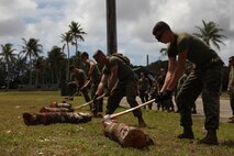 Corpsmen and Marines chop logs March 15 during a field meet on NCTS.  The Marines are part of Guahan Shield, an exercise designed to facilitate multiservice engagements, set conditions for bilateral and multilateral training opportunities, and support rapid response to potential crises and contingency operations in the Asia-Pacific region.  The Marines are part of Combat Logistics Detachment 39, 9th Engineer Support Battalion, 3rd Marine Logistics Group, III Marine Expeditionary Force. 