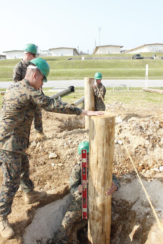 Combat engineers install support beams Feb. 28 during the construction of a new obstacle course at Camp Courtney. The Marines are constructing the course to replace an old course that had become unserviceable after years of use and exposure to the elements. 9th ESB is part of 3rd Marine Logistics Group, III Marine Expeditionary Force. 