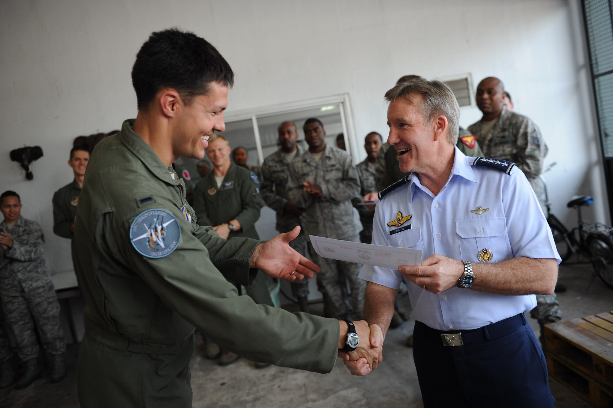 U.S. Air Force Gen. Hawk Carlisle, commander of Pacific Air Forces, presents certificates of appreciation for outstanding performance to Airmen before the closing ceremony for Cope Tiger 13 at Korat Royal Thai Air Force Base, Thailand, March 22, 2013. More than 300 U.S. service members are participating in CT13, which offers an unparalleled opportunity to conduct a wide spectrum of large force employment air operations and strengthen military-to-military ties with two key partner nations, Thailand and Singapore. (U.S. Air Force photo/2nd Lt. Jake Bailey)