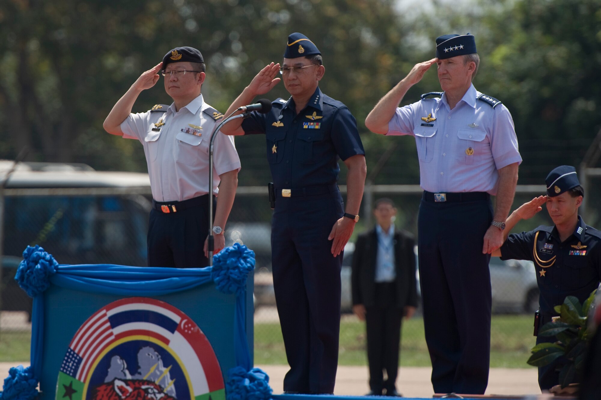 From right to left, Gen. Hawk Carlisle, commander of Pacific Air Forces, Commander in Chief of the Royal Thai Air Force Air Chief Marshal Prajin Juntong and Singapore's Chief of Air Force (Designate) Brig. Gen. Hoo Cher Mou, salute during the closing ceremony for Cope Tiger 13 at Korat Royal Thai Air Force Base, Thailand, March 22, 2013. More than 300 U.S. service members are participating in CT13, which offers an unparalleled opportunity to conduct a wide spectrum of large force employment air operations and strengthen military-to-military ties with two key partner nations, Thailand and Singapore. (U.S. Air Force photo/2nd Lt. Jake Bailey)