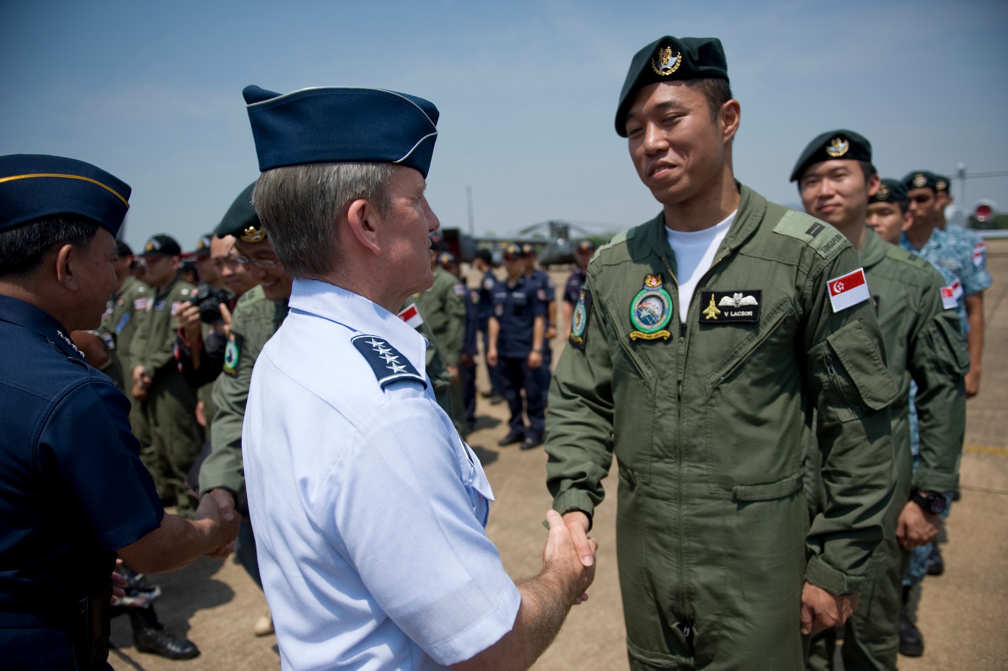 U.S. Air Force Gen. Hawk Carlisle, commander of Pacific Air Forces, thanks Airmen from the Republic of Singapore during the closing ceremony for Cope Tiger 13 at Korat Royal Thai Air Force Base, Thailand, March 22, 2013. More than 300 U.S. service members are participating in CT13, which offers an unparalleled opportunity to conduct a wide spectrum of large force employment air operations and strengthen military-to-military ties with two key partner nations, Thailand and Singapore. (U.S. Air Force photo/2nd Lt. Jake Bailey)