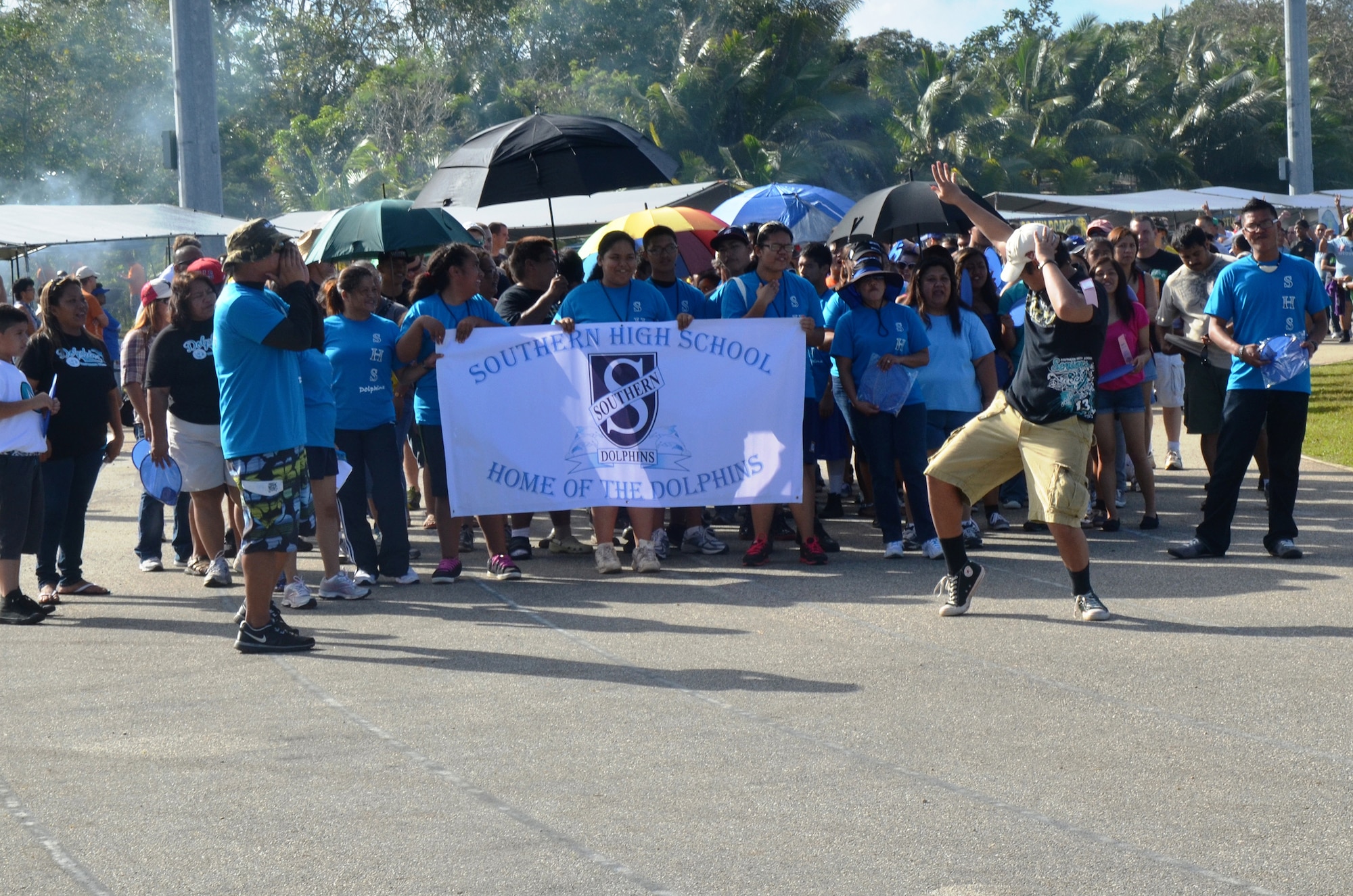 Members from Southern High School join with service members and volunteers to accompany the athletes as they walk in the opening parade during the 37th Annual Special Olympics of Guam Track and Field event at Okkodo High School in Dededo, Guam, March 23, 2013.  The Special Olympics mission is to provide year-round sports training and athletic competition in a variety of Olympic-type sports for children and adults with intellectual disabilities, giving them continuing opportunities to develop physical fitness and demonstrate courage. (U.S. Air Force photo/Staff Sgt. Veronica McMahon/Released)