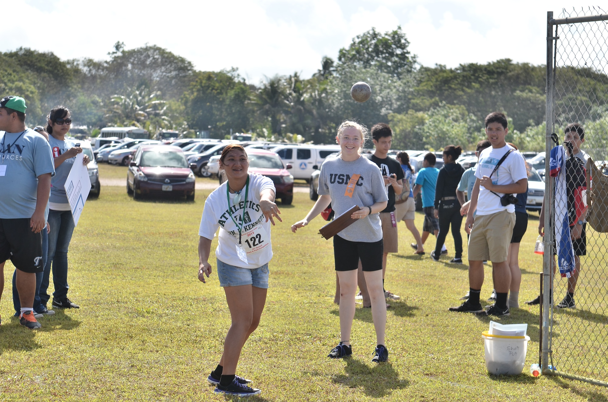 Marine Corps Cpl. Siobhan Bermudez (right), 9th Engineer Support Battalion administrative specialist, cheers on Ronette Babuta (left), Special Olympics athlete, in the shot put event during the 37th Annual Special Olympics of Guam Track and Field event at Okkodo High School in Dededo, Guam, March 23, 2013.  More than 300 service members from all military branches came together to support Special Olympic athletes in a variety of Olympic-type sports for children and adults with intellectual disabilities, giving them continuing opportunities to develop physical fitness and demonstrate courage.  (U.S. Air Force photo/Staff Sgt. Alexandre Montes/Released)