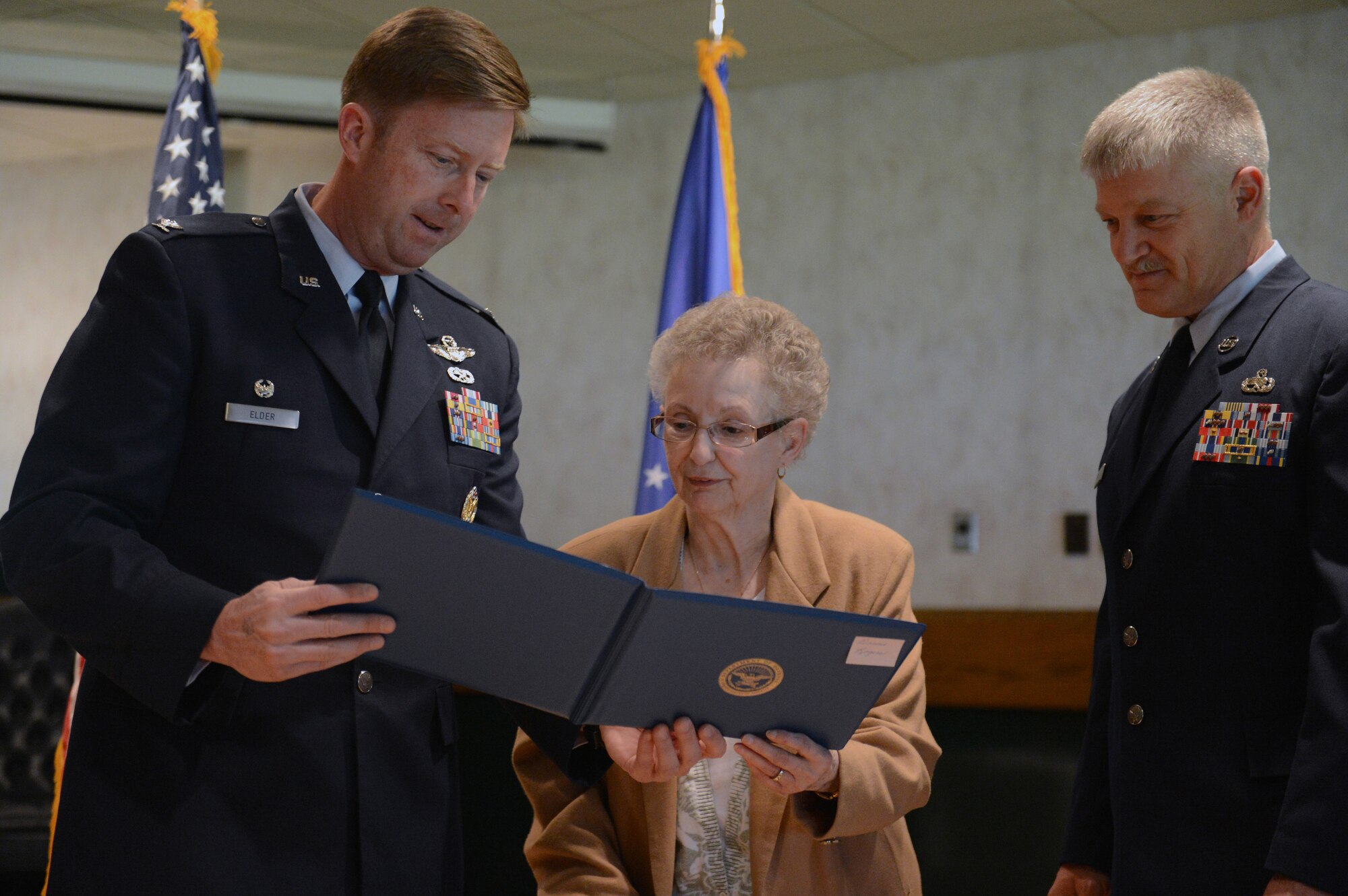 Col. Wyn Elder, 62nd Airlift Wing commander, shows Dorine Rogers, widow of a Vietnam veteran, a certificate honoring her March 23, 2013 at Joint Base Lewis-McChord, Wash. The 62nd Airlift Wing hosted a ceremony to thank and honor Vietnam veterans and their family members as part of the Department of Defense's commemoration of the Vietnam War’s 50th anniversary program. (U.S. Air Force photo/Airman 1st Class Jacob Jimenez)