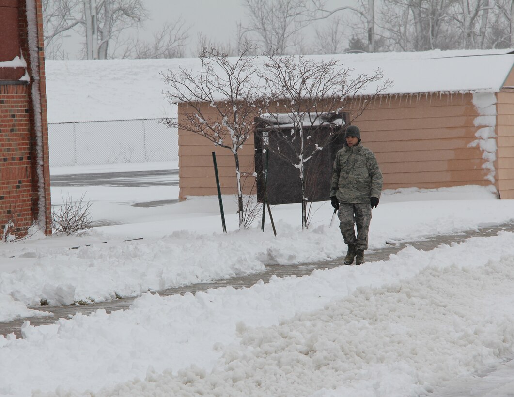 Old man winter strikes again at the base.  It's hard to believe but snowy days are still around at the beginning of Spring for the 932nd Airlift Wing.  With only 7 days until the Cardinals opening baseball game, snow hit the area hard.  Delayed weather reporting happened today after up to 10 inches of snow fell throughout the Saint Louis area Sunday.  Building managers at the unit got out and about to clear walkways with civil engineering assistance.  (U.S. Air Force photo/Maj. Stan Paregien)