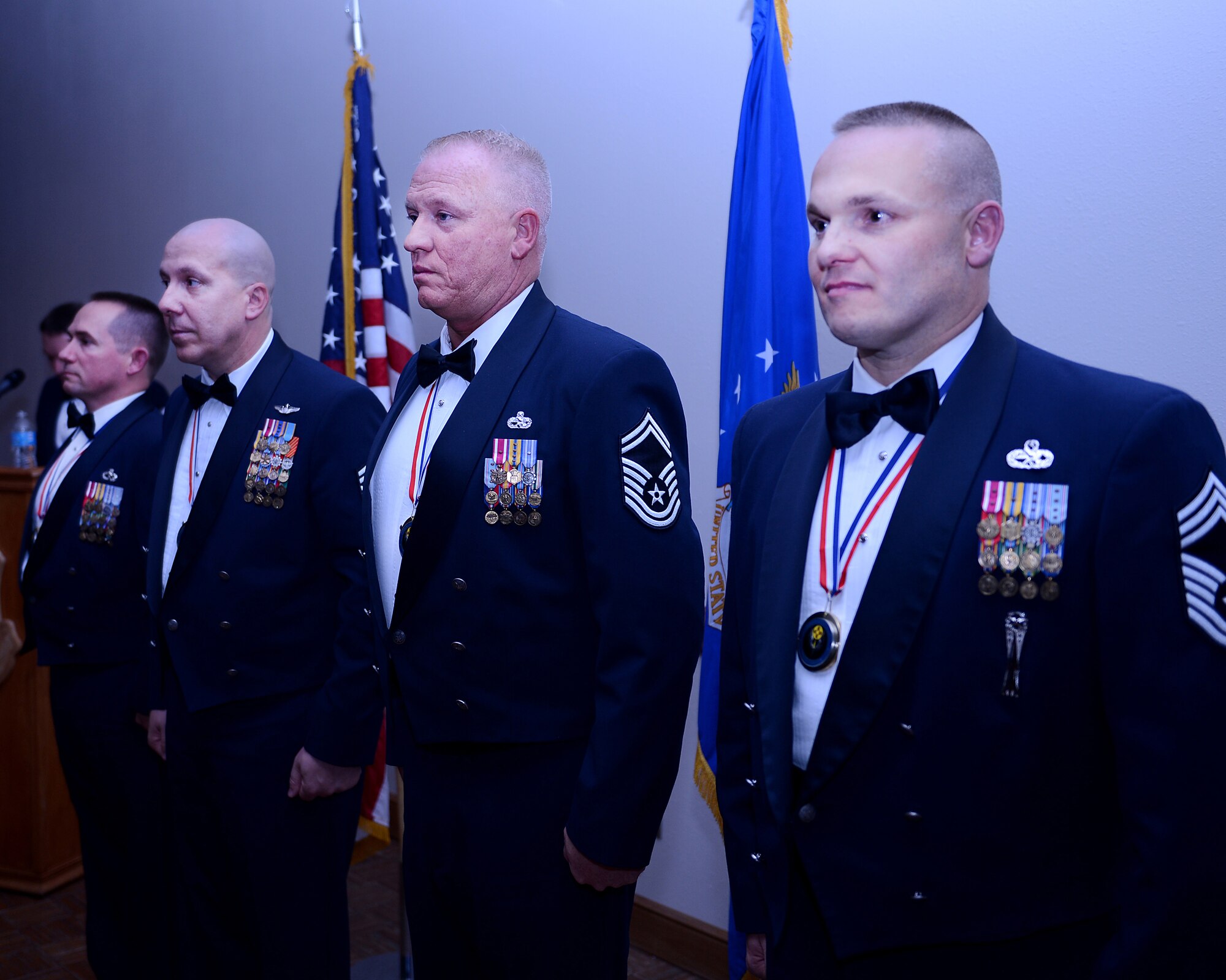 U.S. Air Force Chief Master Sgt. Anthony Steffen (right), Senior Master Sgt. Timothy Jordan (right center), Senior Master Sgt. Barry Fegan (left center) and Senior Master Sgt. William Caton III (left) stand ready to accept their new duties and responsibilities as chief master sergeants March 22, 2013. The 2013 Chief Master Sergeant Recognition Ceremony was held at The Landing Zone to pay tribute to Cannon’s latest Chief Master Sgt. selects for their outstanding leadership and service.  (U.S. Air Force photo/Staff Sgt. Matthew Plew)