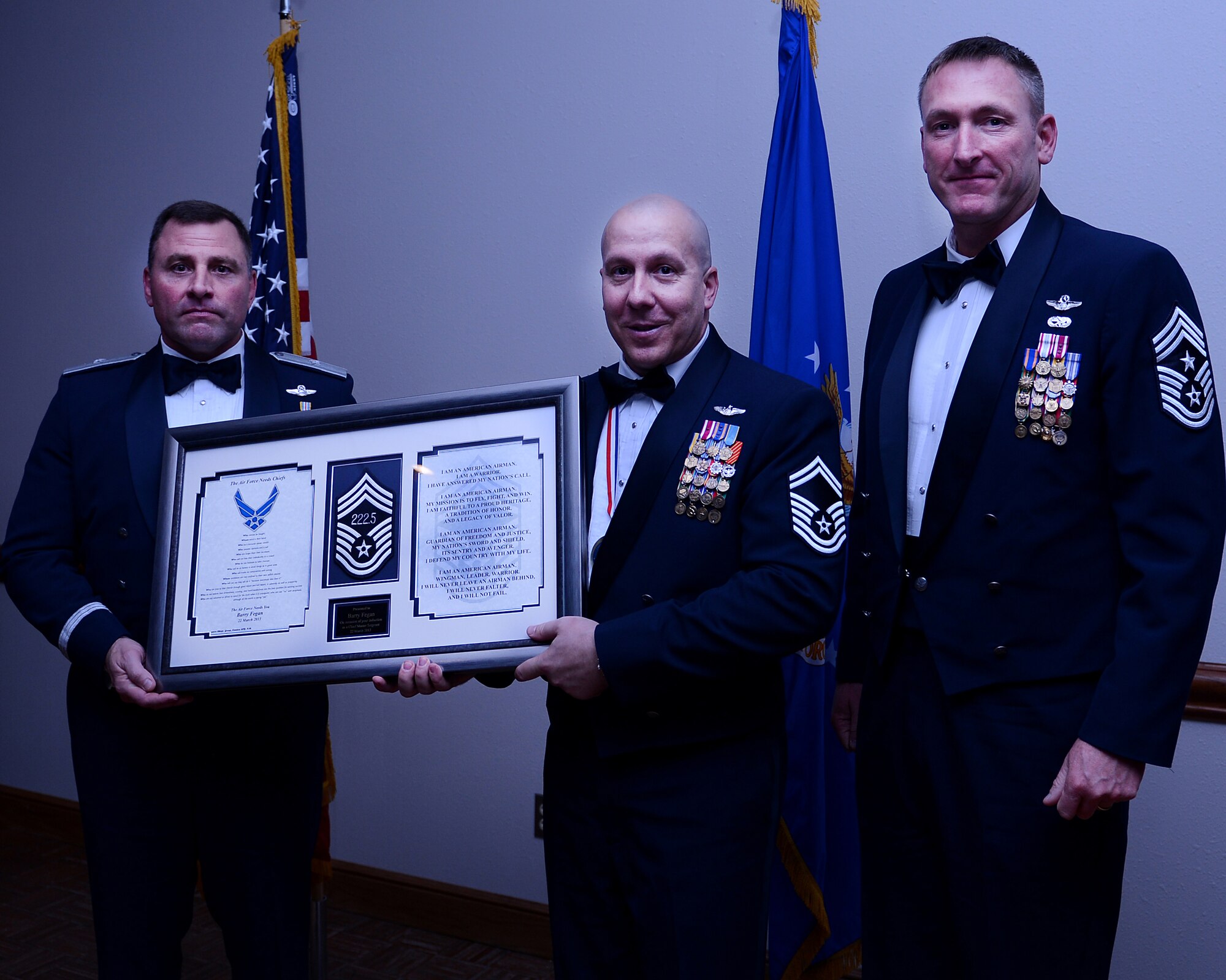 U.S. Air Force Brig. Gen. Timothy Leahy, 23rd Air Force commander (left), accompanied by Chief Master Sgt. Paul Henderson, 27th Special Operations Wing command chief (right), present stripes to Senior Master Sgt. Barry Fegan (center), March 22. The 2013 Chief Master Sergeant Recognition Ceremony was held at The Landing Zone to pay tribute to Cannon’s latest chief master sergeant selects for their outstanding leadership and service. (U.S. Air Force photo/Staff Sgt. Matthew Plew) (U.S. Air Force photo/Staff Sgt. Matthew Plew)