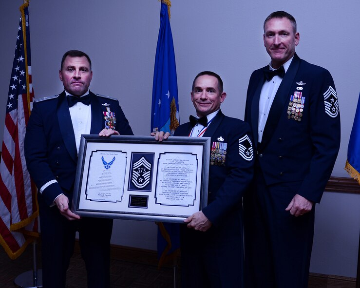U.S. Air Force Brig. Gen. Timothy Leahy, 23rd Air Force commander (left), accompanied by Chief Master Sgt. Paul Henderson, 27th Special Operations Wing command chief (right), present stripes to Senior Master Sgt. William Caton III (center), March 22, 2013. The 2013 Chief Master Sergeant Recognition Ceremony was held at The Landing Zone to pay tribute to Cannon’s latest chief master sergeant selects for their outstanding leadership and service. (U.S. Air Force photo/Staff Sgt. Matthew Plew) (U.S. Air Force photo/Staff Sgt. Matthew Plew)