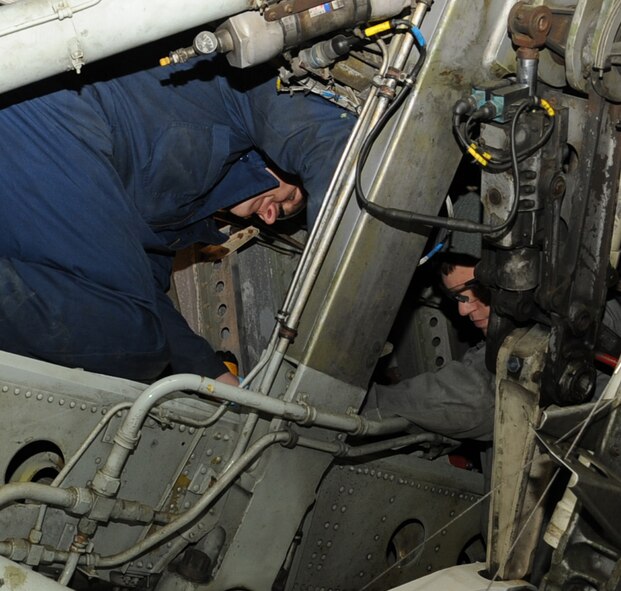 Senior Airmen Corey Crawford and Michael Romanyak, 2nd Maintenance Squadron Aircraft Structural Maintenance, work on the wheel well of a B-52H Stratofortress on Barksdale Air Force Base, La., March 25. Structural maintainers are responsible for corrosion control, structural maintenance and repairing rivets and the skin of a B-52H Stratofortress. (U.S. Air Force photo/Senior Airman Sean Martin)