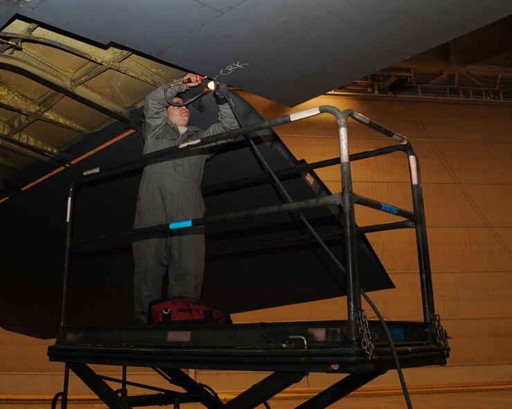 Staff Sgt. Dustin Reynolds, 2nd Maintenance Squadron Aircraft Structural Maintenance, removes a jo-bolt on the wing of a B-52H Stratofortress on Barksdale Air Force Base, La., March 25. The bolt is used to hold brackets to the aircraft. (U.S. Air Force photo/Senior Airman Sean Martin)