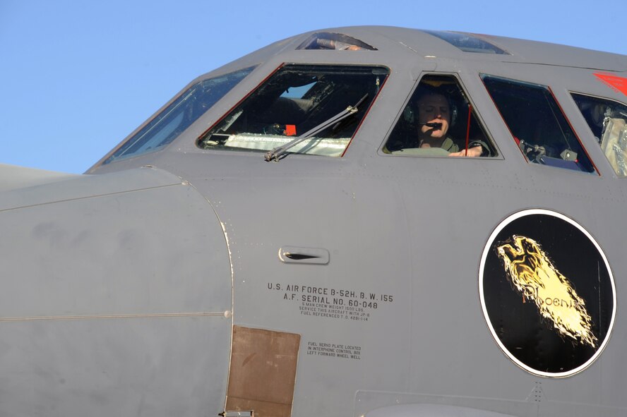 Maj. Aaron Tillman, 20th Bomb Squadron aircraft commander, communicates with crew chiefs on the ground while performing interior checks inside a B-52H Stratofortress on Barksdale Air Force Base, La., March 25. If there are no problems during startup, the crew chiefs begin to taxi the aircraft to the runway for take-off. (U.S. Air Force photo/Airman 1st Class Benjamin Gonsier)