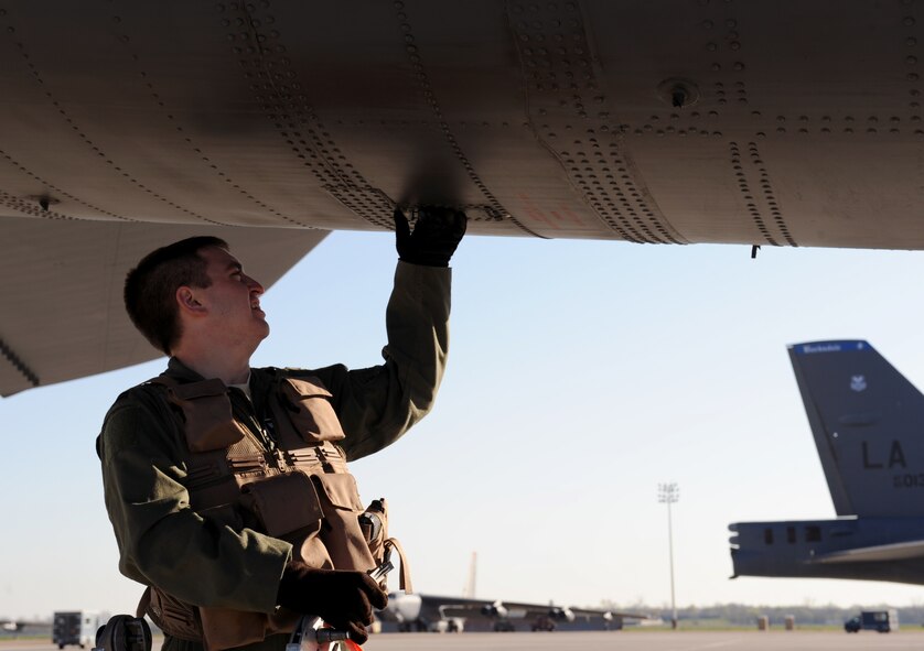 Capt. Douglas Lewandowski, 20th Bomb Squadron electronic warfare officer, checks a part of a B-52H Stratofortress on Barksdale Air Force Base, La., March 25. Each member of the aircrew has his or her own specific items they check when conducting aircraft inspections before take-off. (U.S. Air Force photo/Airman 1st Class Benjamin Gonsier)