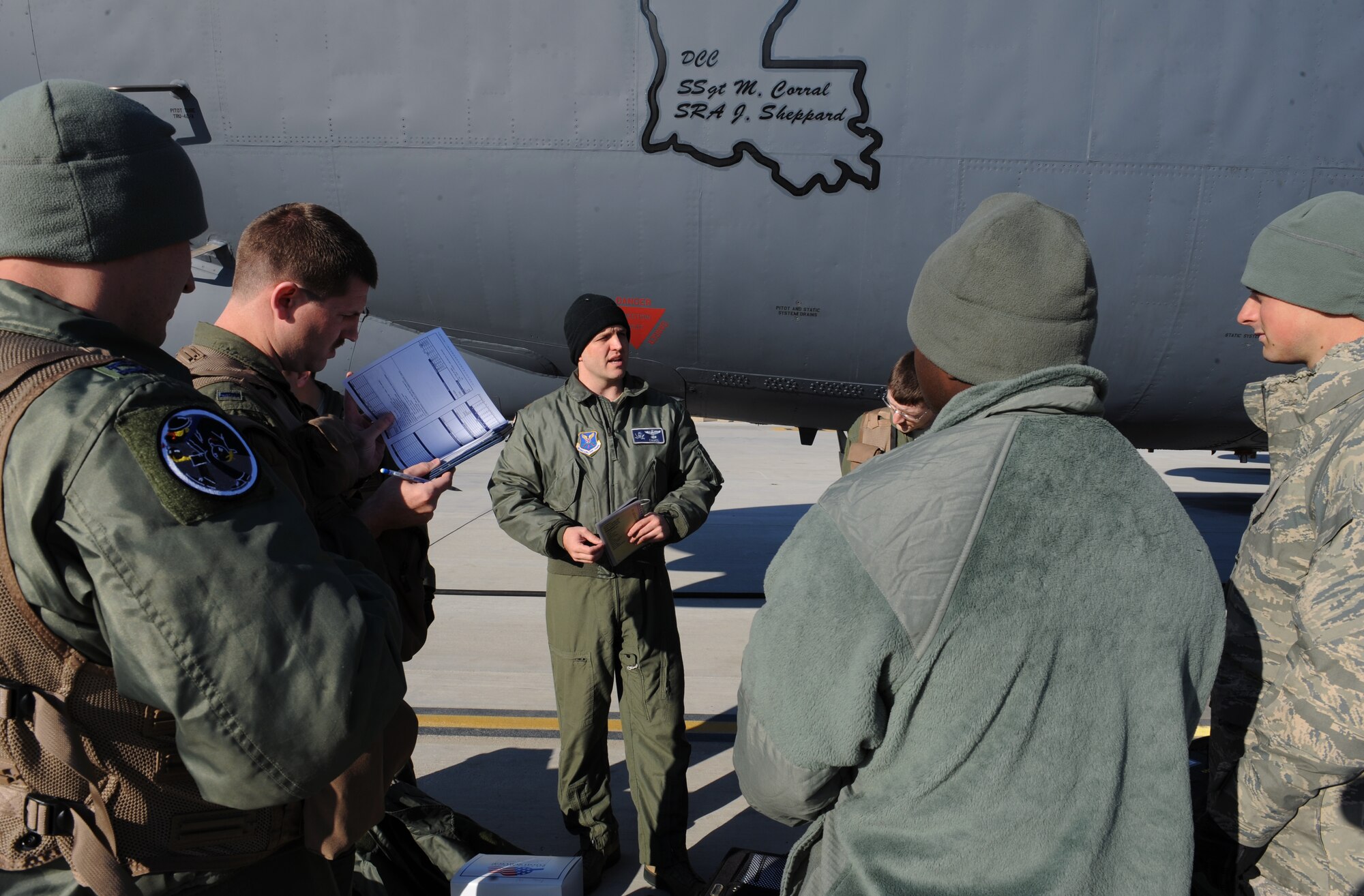 Maj. Aaron Tillman, 20th Bomb Squadron aircraft commander, speaks with crew chiefs about the condition of the aircraft on Barksdale Air Force Base, La., March 25. The aircrew discuss the type of mission they are performing, the general procedures for ground checks and starting the engines with the crew chiefs. (U.S. Air Force photo/Airman 1st Class Benjamin Gonsier)
