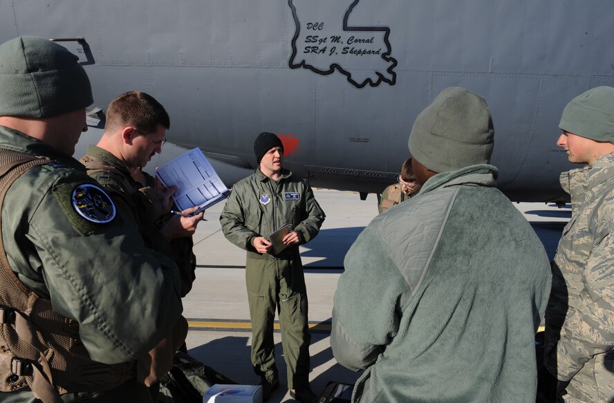 Maj. Aaron Tillman, 20th Bomb Squadron aircraft commander, speaks with crew chiefs about the condition of the aircraft on Barksdale Air Force Base, La., March 25. The aircrew discuss the type of mission they are performing, the general procedures for ground checks and starting the engines with the crew chiefs. (U.S. Air Force photo/Airman 1st Class Benjamin Gonsier)