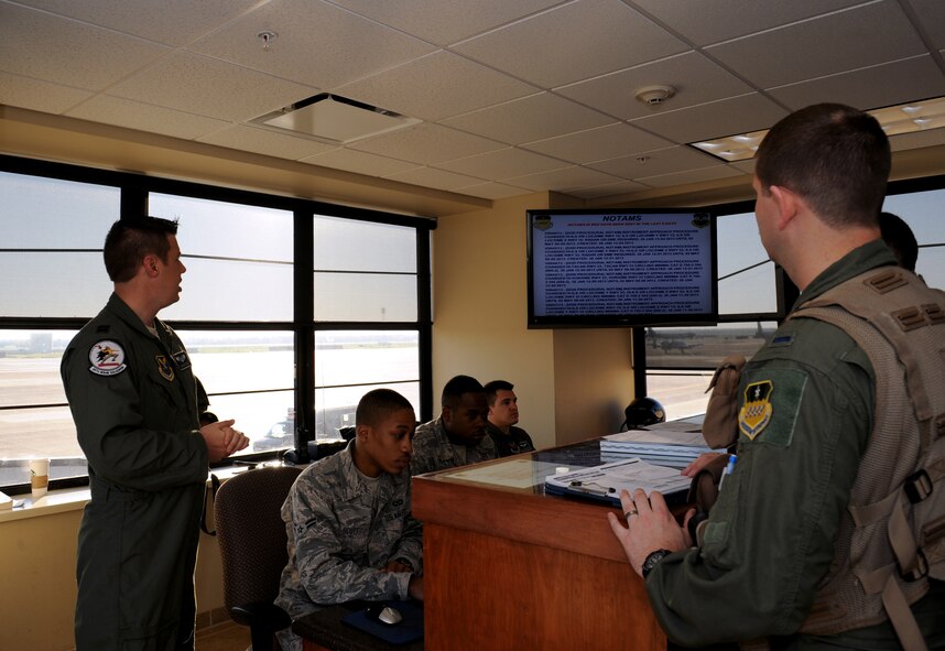 Capt. Adam Friesz, 20th Bomb Squadron, briefs aircrew members at the step desk on Barksdale Air Force Base, La., March 25. During the step briefing, aircrew members are briefed on weather conditions, where their aircraft is parked and file paperwork. (U.S. Air Force photo/Airman 1st Class Benjamin Gonsier)