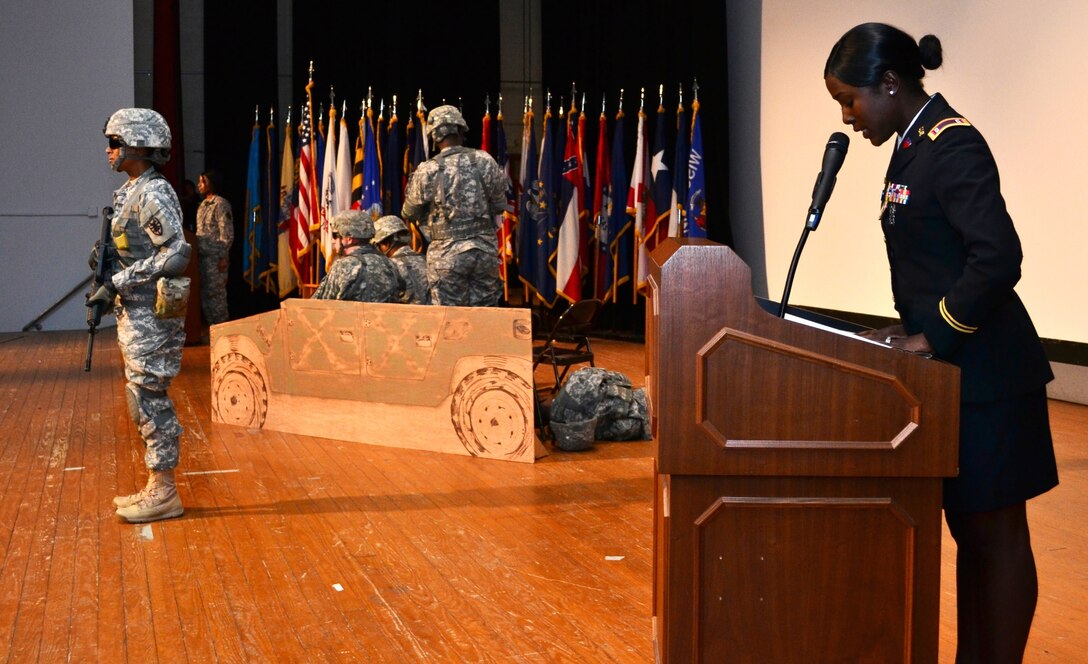 U.S. Army Warrant Officer CyTique Johnson (right), a human resource technician with the 7th Sustainment Brigade, narrates the theater representation of women in combat, during the 7th Sus. Bde.’s “Women Inspiring Innovation through Imagination” event at Jacobs Theater at Fort Eustis, Va., March 19, 2013. The observance, hosted by 7th Sus. Bde. commander Col. Jennifer Reinkober, featured rich history and highlighted the extraordinary achievements of American women. (U.S. Army photo by Sgt. Edwin Rodriguez/Released)