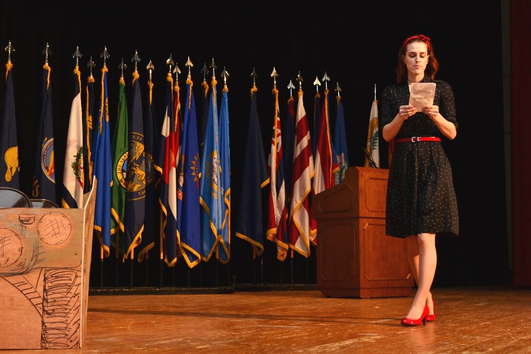 U.S. Army Sergeant 1st Class Jaime Hawley, 7th Sustainment Brigade Sexual Assault Response Coordinator, performs on stage as the “housewife” during a theater representation of women in the early 20th century during the 7th Sus. Bde.’s “Women Inspiring Innovation Through Imagination” event at Jacobs Theater at Fort Eustis, Va., March 19, 2013. The observance, hosted by 7th Sus. Bde. commander Col. Jennifer Reinkober, featured rich history and highlighted the extraordinary achievements of American women. (U.S. Army photo by Sgt. Edwin Rodriguez/Released)