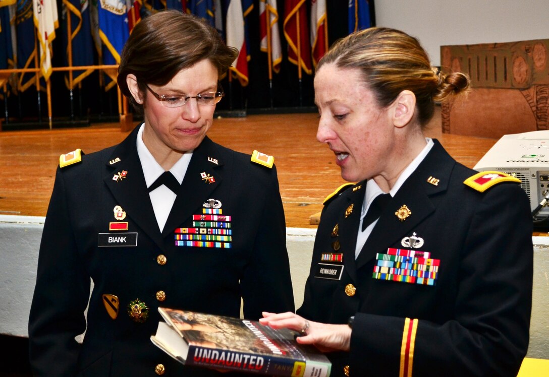 (From left) U.S. Army Col. Maria Biank, the 93rd Signal Brigade commander, speaks to Col. Jennifer Reinkober, the 7th Sustainment Bde. commander, before the 7th Sus. Bde.’s “Women Inspiring Innovation Through Imagination” event at Jacobs Theater at Fort Eustis, Va., March 19, 2013. The observance, hosted by Reinkober, featured rich history and highlighted the extraordinary achievements of American women. (U.S. Army photo by Sgt. Edwin Rodriguez/Released)