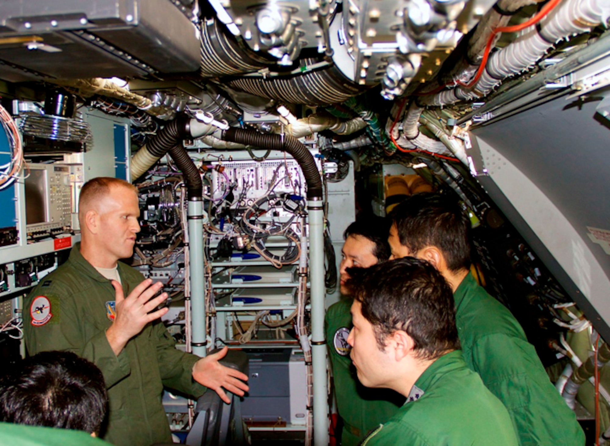 Capt. Christopher Jordan, 82nd Reconnaissance Squadron, briefs members of the Japan Air Self Defense Force, during an aircrew exchange on a static RC-135 V/W Rivet Joint March 12 at Kadena Air Base, Japan. During the exchange, air crew members from the U.S. Air Force and JASDF were able to ensure a good understanding of new and improved technologies and enhance interoperability through face-to-face discussions. (Courtesy photo)
