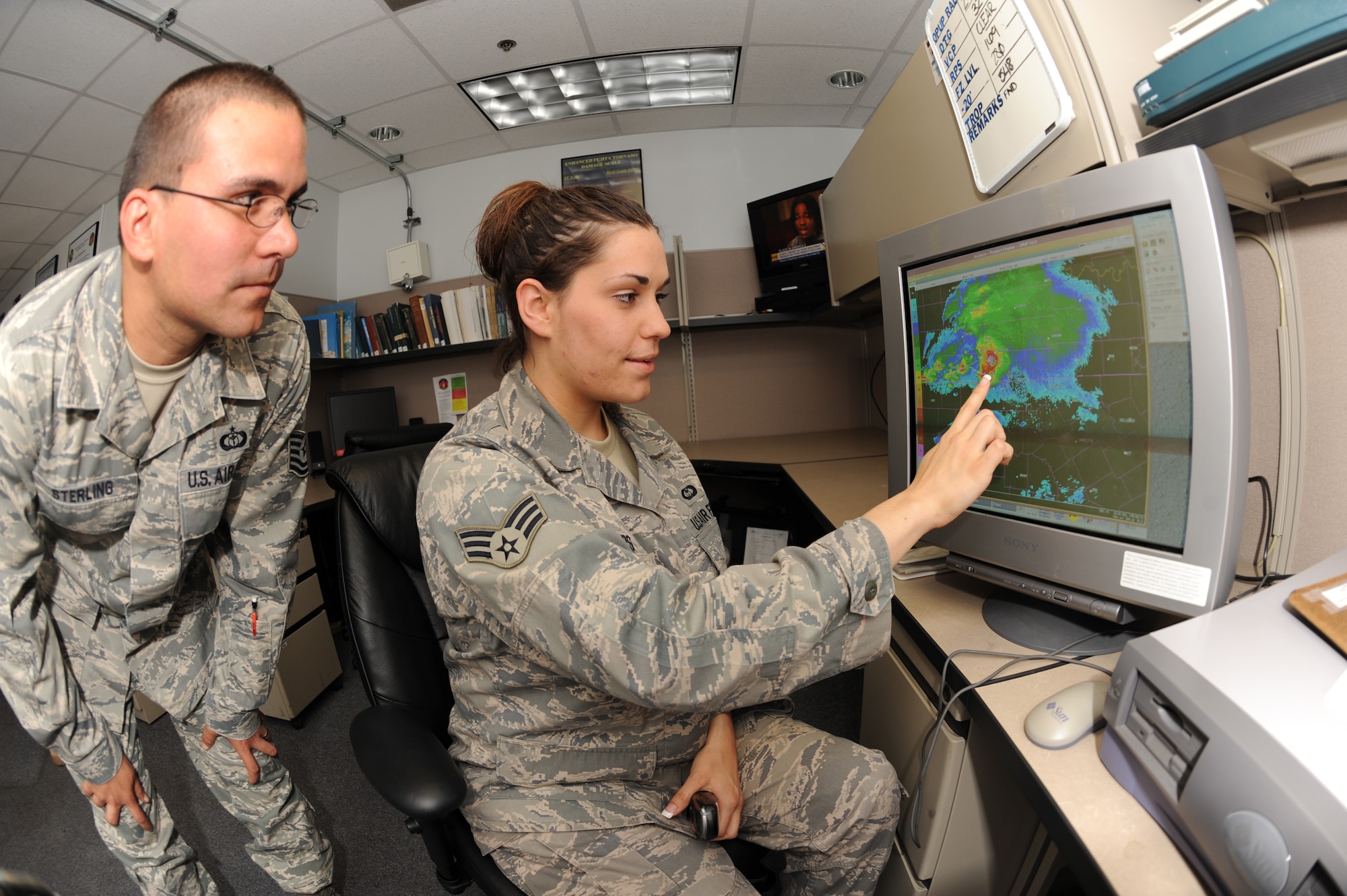 Senior Airman Ann Winters and Tech. Sgt. Mark Sterling, 7th Operations Support Squadron, observe the severe weather radar June 24 here. The weather flight uses the radar system to interrogate severe weather when activity is detected. They have 30 minutes prior to the actual event to warn the Dyess populous of a tornado, and two hours to give notice of any other severe weather. (U.S. Air Force photo by Senior Airman Jennifer Romig)
