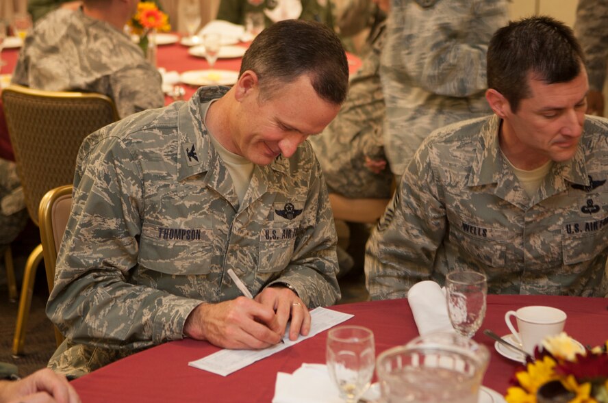 U.S. Air Force Col. Billy Thompson, 23d Wing commander, signs the first donation for the Air Force Assistance Fund March 25, 2013, at Moody Air Force Base, Ga. The goal for Moody this year is $84,154. Donations can be made to four organizations: the Air Force Aid Society, the Air Force Enlisted Village, the Air Force Villages and the General and Mrs. Curtis E. LeMay Foundation. (U.S. Air Force Photo by Airman Paul Francis/Released)
