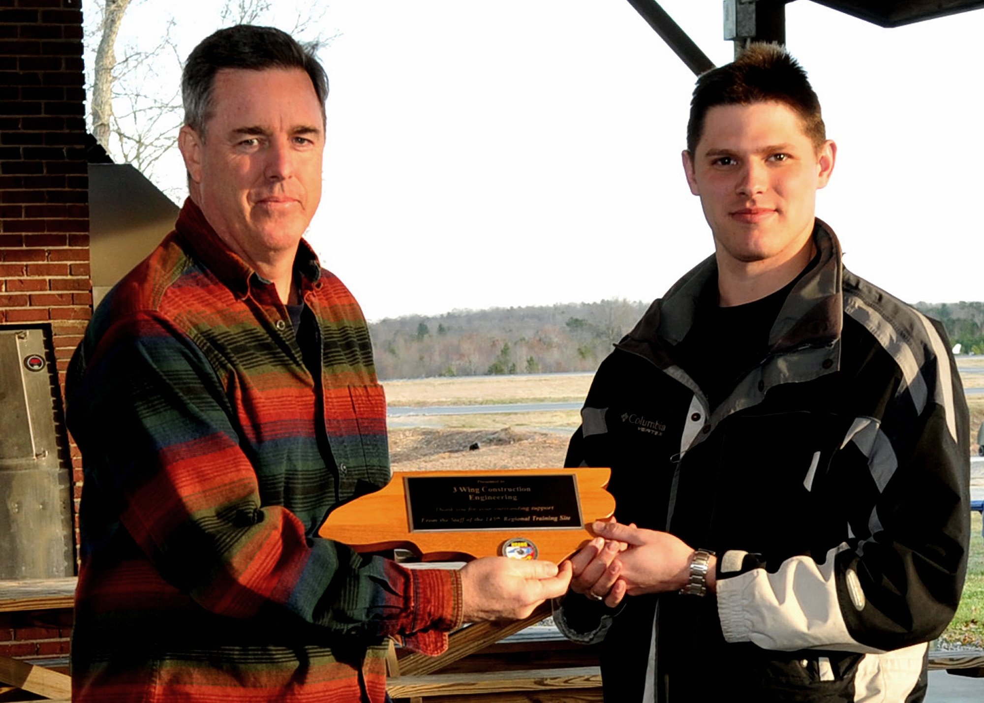 NEW LONDON, N.C.  – On March 10, 2013, Lt. Col. Timothy Moran, Deputy Commander, 145th Engineer Squadron presents a plaque of the state of North Carolina to Lt. Sylvain Fournier, Officer in Charge, Royal Air Force 3 Wing Construction Engineers Canadian Forces from Bagotville, Quebec, as a token of thanks for the professionalism, hard work and dedication of the 26,  3 Wing Royal Air Force engineers that participated in the Deployment for Training Program hosted by 145th Civil Engineering Squadron at the North Carolina Air National Guard Regional Training Site in New London, N.C. This two week program is an exchange agreement between the Royal Canadian Air Force and the United States Air National Guard.  (National Guard Photo by Tech. Sgt. Patricia Findley, 145th Public Affairs) 

