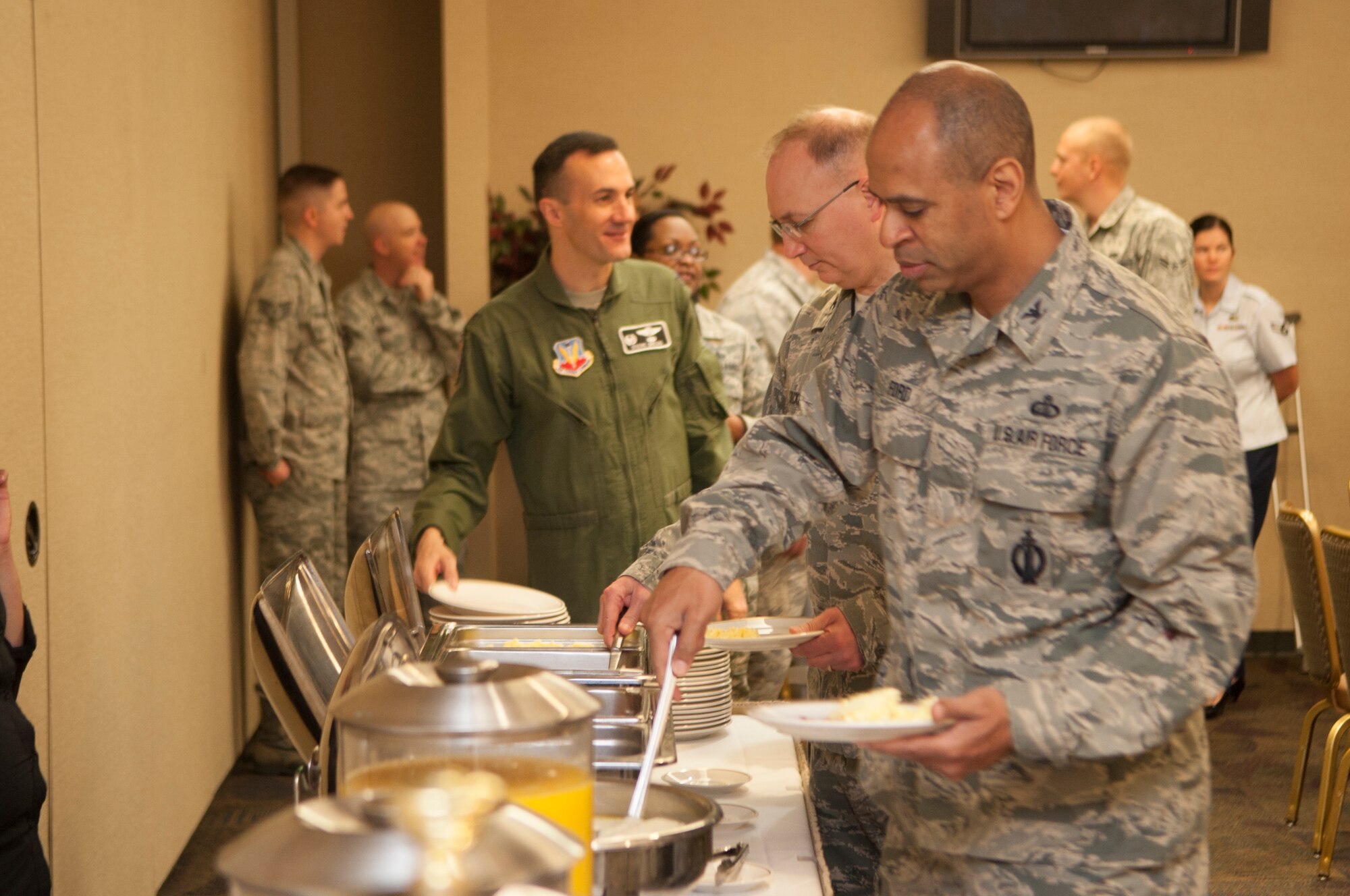 U.S. Air Force Col. Edward Ford, 23d Mission Support Group commander, grabs food at the Air Force Assistance Fund kick-off breakfast March 25, 2013, at Moody Air Force Base, Ga. The goal of the AFAF is to raise funds for the charitable affiliates that provide support to active duty, retirees, reservists, guard and their dependents. (U.S. Air Force Photo by Airman Paul Francis/Released)

