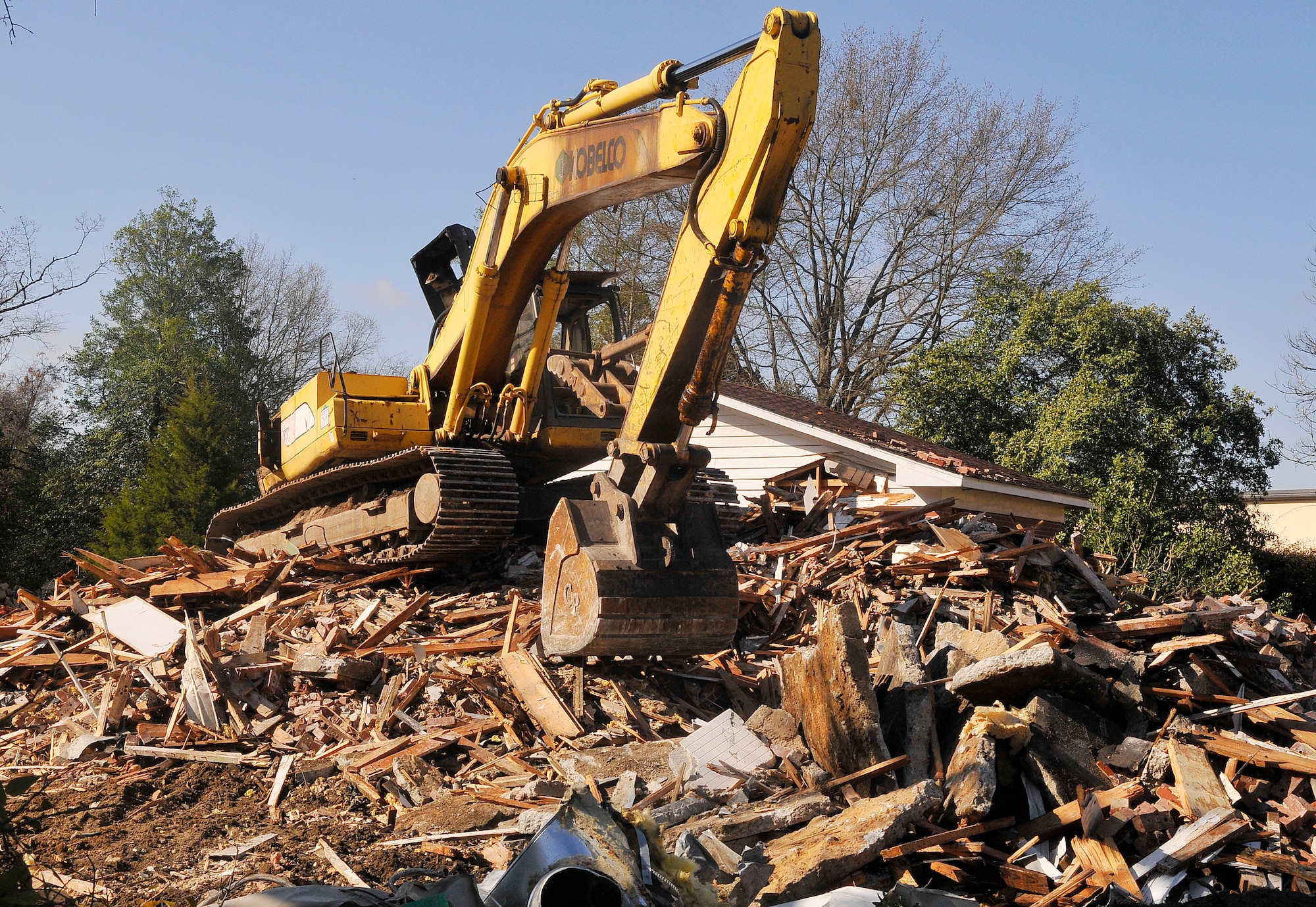 Contractors work to bring down a house at Chief’s Circle March 18. Four of the five housing units located at Chief’s Circle are being demolished due to age and the cost to maintain them. The other unit will remain in place for base use. In addition to the selected homes, all of the asphalt drives and roads will also be demolished. The resulting free space will be a green area. The scheduled completion date for this contract is April 15. (U.S. Air Force photo by Sue Sapp)
