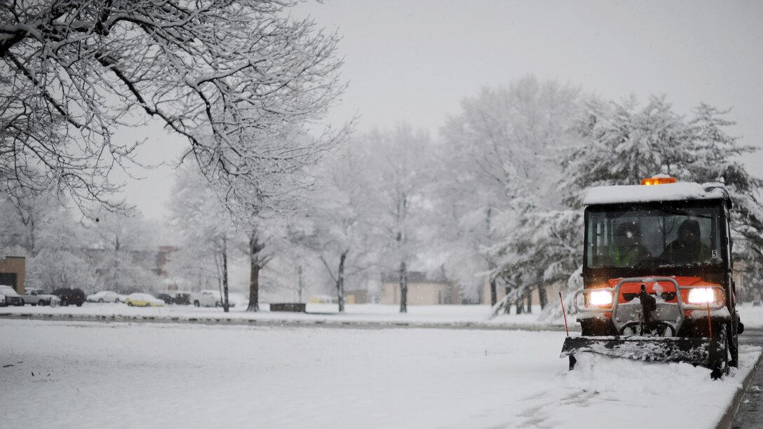 Personnel clear snow from the sidewalk at Joint Base Andrews, Md., March 25, 2013. The spring snowstorm is forecasted to bring up to five inches of snow to the local area. (U.S. Air Force photo/Staff Sgt. Nichelle Anderson)