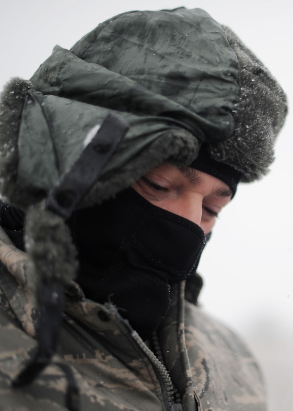 Tech. Sgt. Matthew Cain, 459th Aircraft Maintenance Squadron crew chief dresses in layers to keep warm while working on the flightline at Joint Base Andrews, Md., March 25, 2013. Up to five inches of snow is expected throughout the day making this the heaviest snowstorm of the year. (U.S. Air Force photo Staff Sgt. Nichelle Anderson)