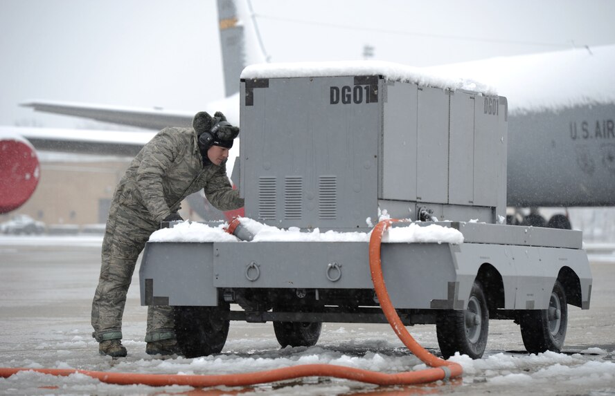Tech. Sgt. Matthew Cain, 459th Aircraft Maintenance Squadron crew chief, starts a generator prior to completing pre-flight inspections on a KC-135 Stratotanker at Joint Base Andrews, Md., March 25, 2013. Personnel continue flightline operations despite a spring snowstorm forecasted to bring up to five inches of snow to the area. (U.S. Air Force photo/Staff Sgt. Nichelle Anderson)
