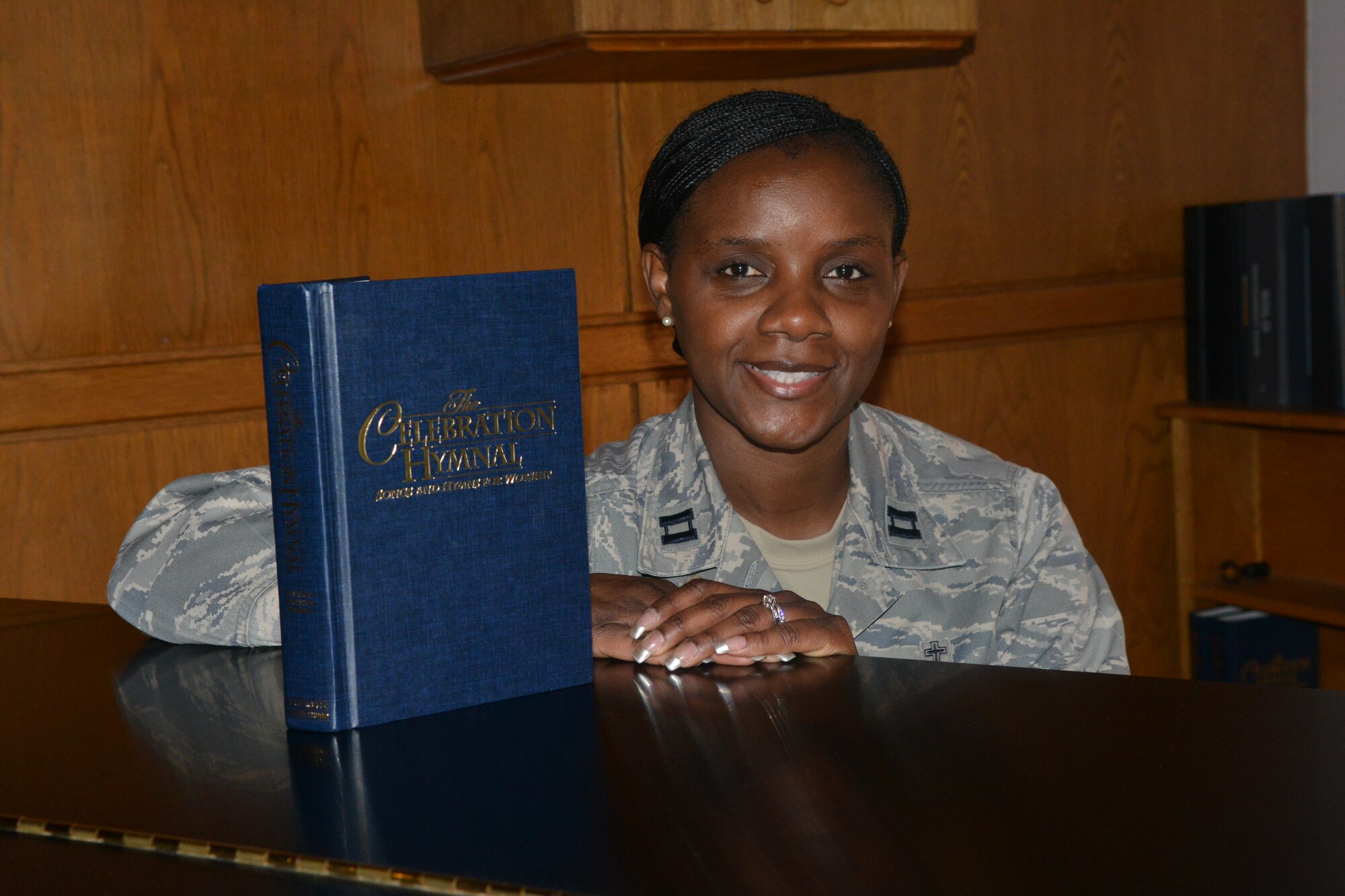 U.S. Air Force Capt. Michelle Law-Gordon, 20th Fighter Wing chaplain, sits by an open hymn book on a break from her daily duties as a chaplain, Shaw Air Force Base, S.C., March 19, 2013. Law-Gordon aims to build a new choir on Shaw and is looking for participants from the Shaw community. (U.S. Air Force photo by Airman 1st Class Ashley L. Gardner/Released)

