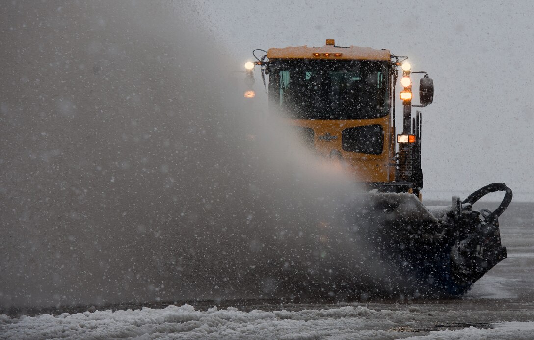 A Snow sweeper from the 11th Civil Engineer Squadron removes snow off the flight line Mar. 25, 2013 at Joint Base Andrews, Md. Up to five inches of snow fell at JBA, marking the first major snowstorm of the year for the area. (U.S. Air Force photo/Staff Sgt. Perry Aston)
