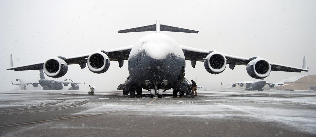 A snow covered Joint Base Lewis-Mchord C-17 Globemaster III, sits on the flightline Mar. 25, 2013 at Joint Base Andrews, Md. Up to five inches of snow fell at JBA, marking the first major snowstorm of the year for the area. (U.S. Air Force photo/Staff Sgt. Perry Aston)