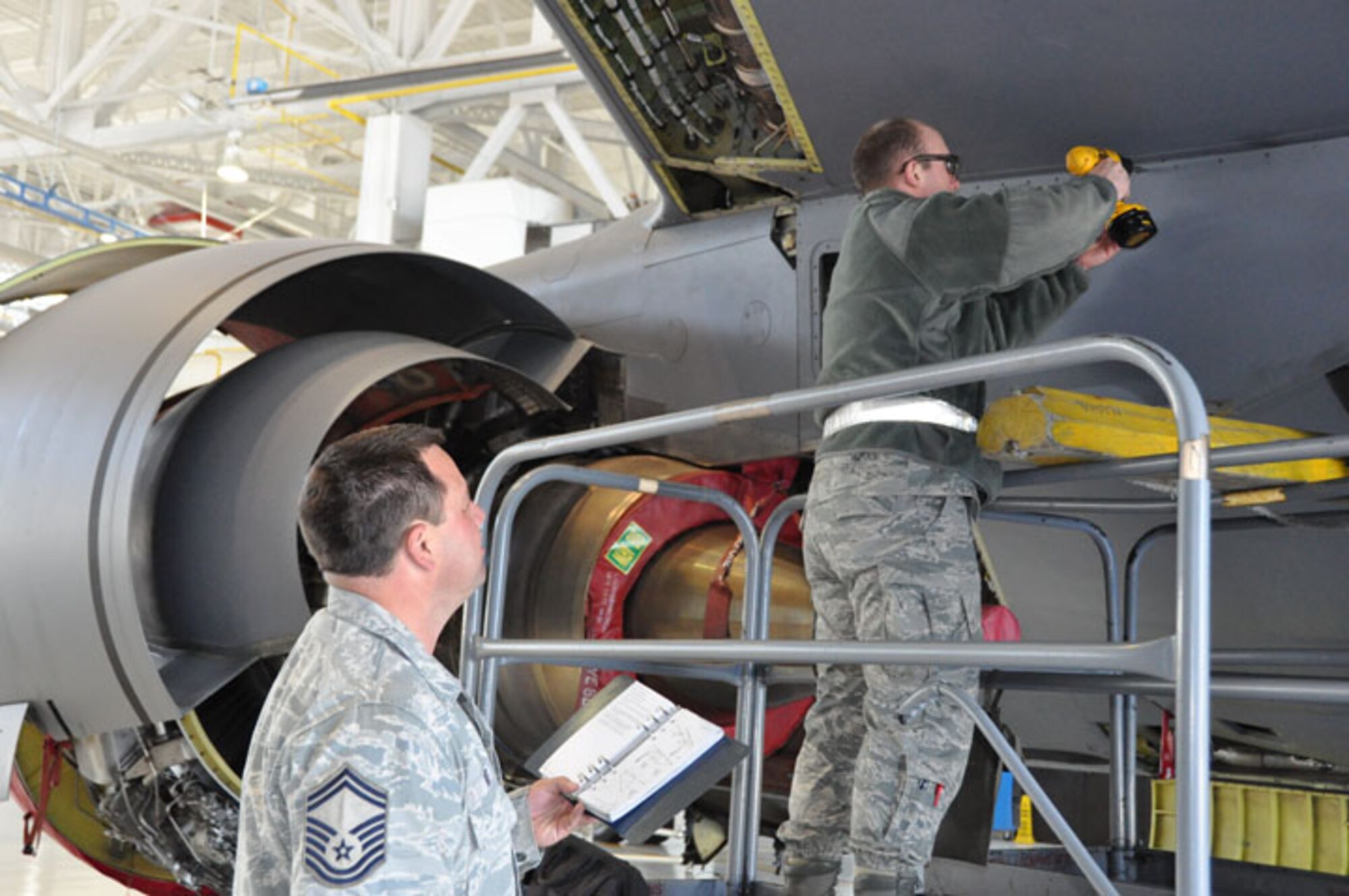 Senior Master Sgt. Jimmy Tart (left) reviews aircraft maintenance taking place in mid-March. Tart recently won a prestigious award at the command level. (USAF photo by Ms. Donna Lea, 916ARW/PA)