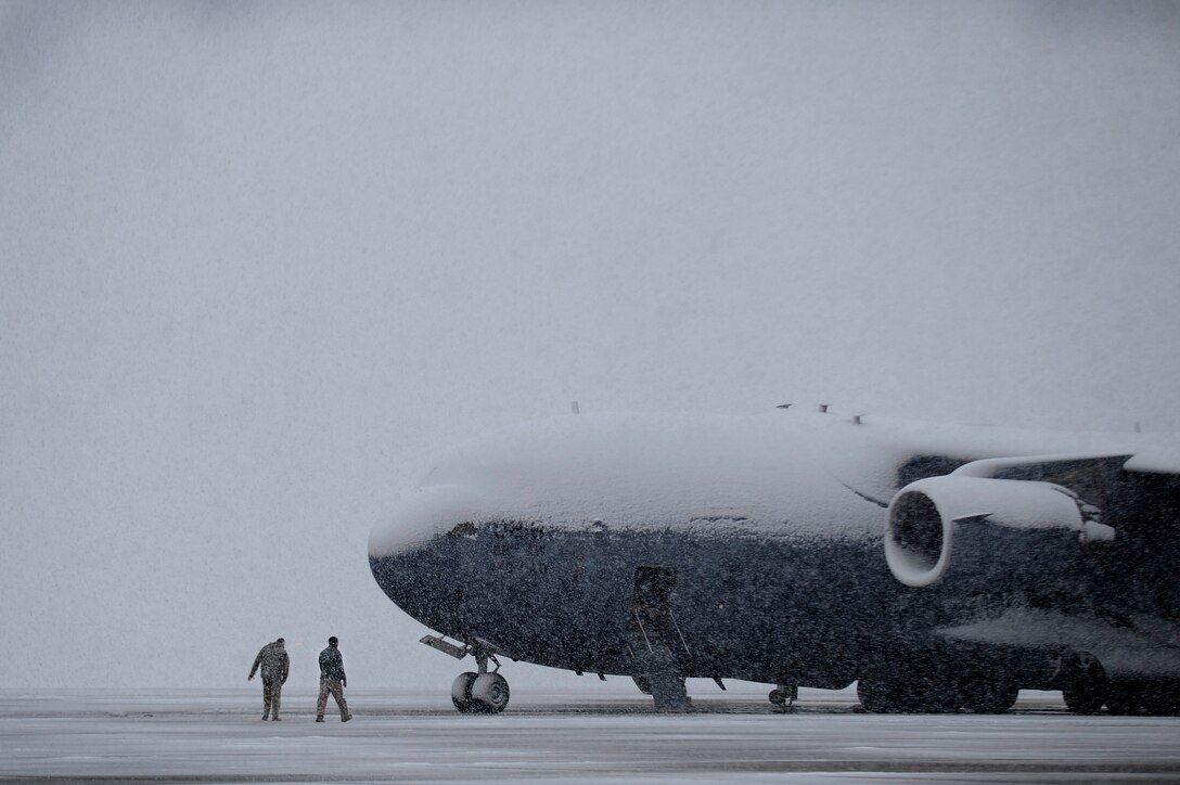 Personnel at Joint Base Andrews, Md., continue flightline operations, March 25, 2013, despite a spring snowstorm forecasted to bring up to five inches of snow to the area. (U.S. Air Force photo/Staff Sgt. Brittany E. Jones)