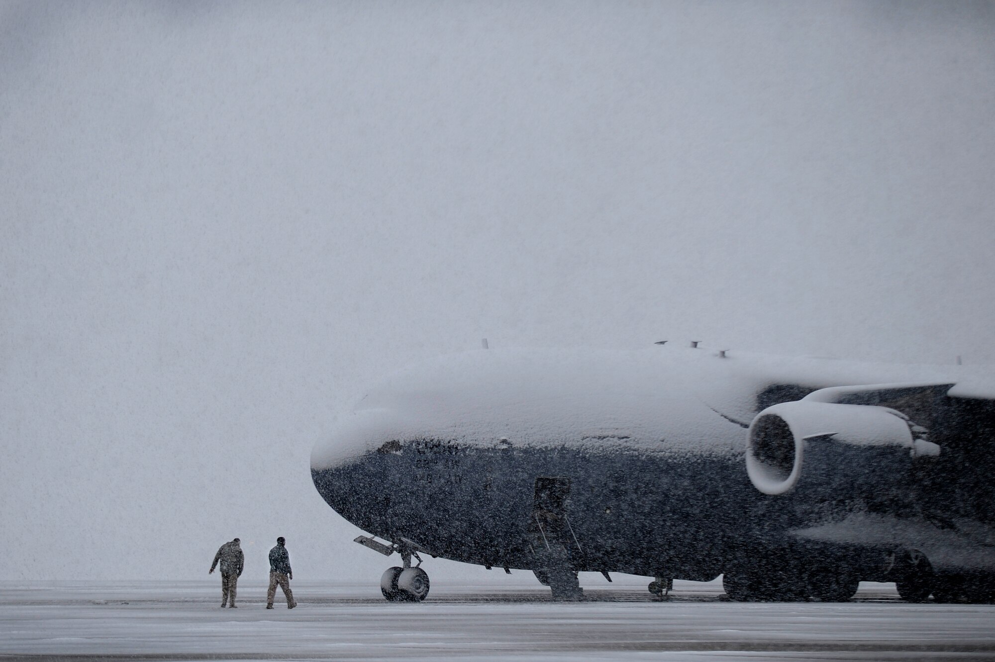 Personnel at Joint Base Andrews, Md., continue flightline operations, March 25, 2013, despite a spring snowstorm forecasted to bring up to five inches of snow to the area. (U.S. Air Force photo/Staff Sgt. Brittany E. Jones)