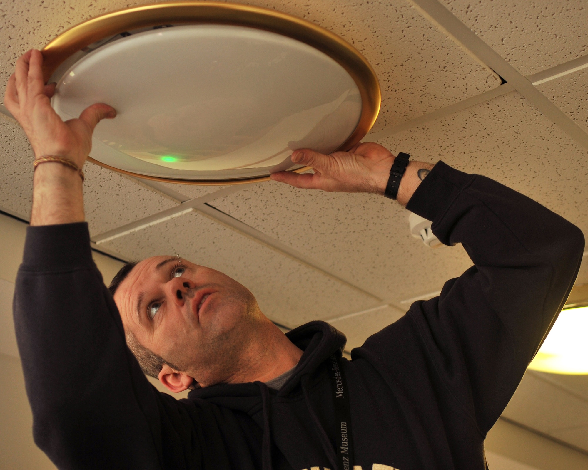 Allen Weale, 100th Civil Engineer Squadron electrician from Lavenham, Suffolk, repairs an emergency light fitting in base lodging March 22, 2013, at RAF Mildenhall, England. Electricians are responsible for repairing and maintaining all base electrical systems. (U.S. Air Force photo by Senior Airman Jerilyn Quintanilla/Released)