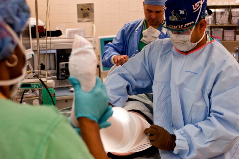 U.S. Army Dr. (Maj.) Rasel Rana, McDonald Army Health Center chief of orthopedic surgery, wraps a patient’s leg during a procedure in the MCAHC operating room at Fort Eustis, Va., March 13, 2013. With a young, active population, the orthopedic surgeons are well equipped to treat sports-related injuries, but they strive to care for all patients that can take advantage of their services. (U.S. Air Force photo by Airman 1st Class R. Alex Durbin/Released)