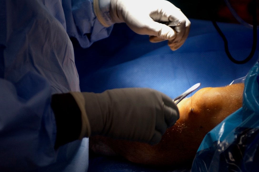 U.S. Army Dr. (Maj.) Rasel Rana, McDonald Army Health Center chief of orthopedic surgery, stiches an incision during a procedure in the MCAHC operating room at Fort Eustis, Va., March 13, 2013. A new operating room is set to open April 26, 2013, and will increase the amount of surgeries each department will be able to offer. The new operating room with be equipped with the latest technology to provide complete, comprehensive care. (U.S. Air Force photo by Airman 1st Class R. Alex Durbin/Released)