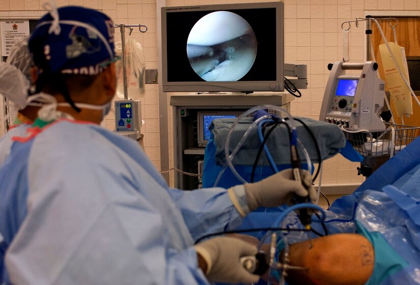 U.S. Army Dr. (Maj.) Rasel Rana, McDonald Army Health Center chief of orthopedic surgery, uses a laparoscopic scope and shaver as he watches the high-definition screen during a procedure in the MCAHC operating room at Fort Eustis, Va., March 13, 2013. The orthopedic center is a referral based, sub-specialty clinic that boasts three orthopedic surgeons and two physician assistants who provide years of knowledge and experience. (U.S. Air Force photo by Airman 1st Class R. Alex Durbin/Released)
