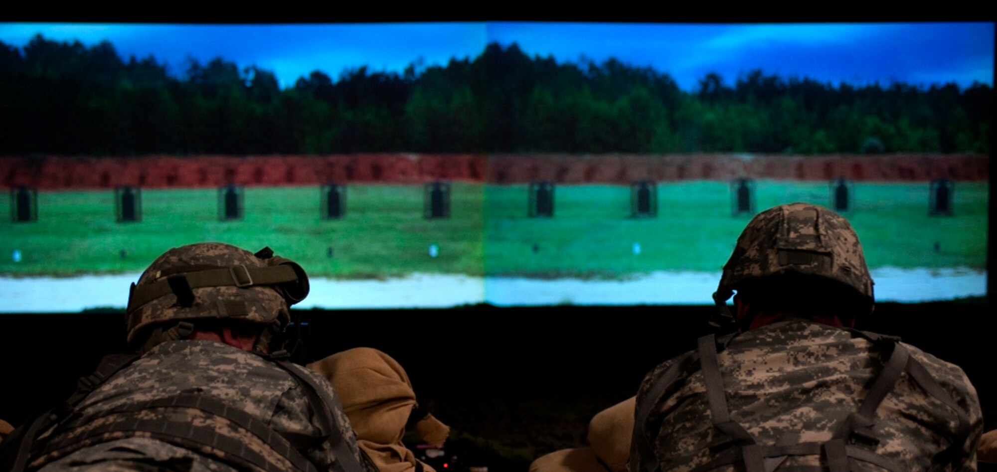 Soldiers prepare to fire while using the Engagement Skills Trainer 2000 at Fort Eustis, Va., March 6, 2013. Simulators like the EST 2000 allow Soldiers to train in a controlled environment and receive immediate feedback on skills that translate directly to the live-fire range. (U.S. Air Force photo by Airman 1st Class R. Alex Durbin/Released) 