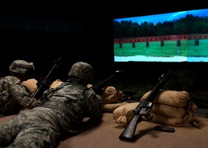 Soldiers clear their rifles after firing while using the Engagement Skills Trainer 2000 at Fort Eustis, Va., March 6, 2013. The EST 2000 is a virtual, computer-based trainer that uses modified, retrofitted weapons to provide initial sustainment marksmanship, advanced marksmanship with stationary and moving targets and reactionary-firing training.  (U.S. Air Force photo by Airman 1st Class R. Alex Durbin/Released) 