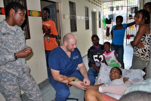 Getting relief supplies into Haiti was problematic, due to lack of adequate port and airfield capacity, following the 2010 earthquake. Here, a special operations Soldier interprets for an American volunteer physician in Haiti. Special operations forces will become increasingly important in the years ahead, according to U.S. Army Training and Doctrine Command's Concepts Development and Learning Directorate. (U.S. Air Force photo by 2nd Lt. Victoria Brayton/Released)