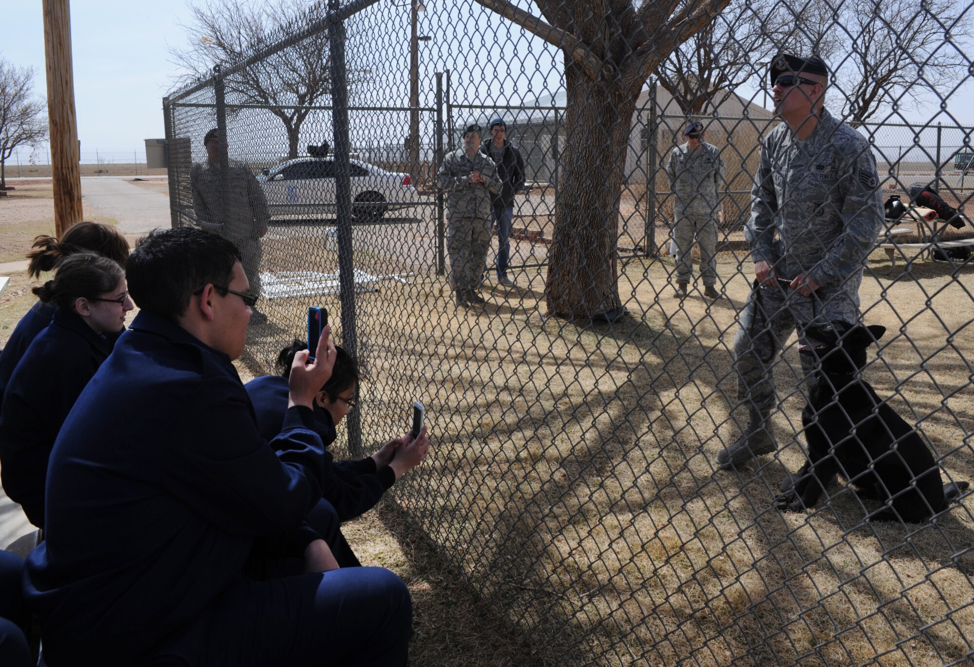 U.S. Air Force Staff Sgt. Joshua Fehringer, 27th Special Operations Security Forces Squadron Military Working Dog handler, speaks to members of the Amarillo division Junior Reserve Officer Training Corps during a tour of Cannon Air Force Base, N.M., March, 20, 2013. Air Force JROTC is the high school variation of the college ROTC program where students can experience military training while achieving their high school education. (U.S. Air Force photo/Airman 1st Class Ericka Engblom)