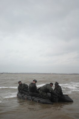 Airmen from the 321st Special Tactics Squadron set up an inflatable motor raft during a water-landing exercise March 15, 2013, off the coast of Ipswich, England. Airmen had to jump form a C-130, land in the water, and inflate a raft during the exercise. (U.S. Air Force photo by Airman 1st Class Dillon Johnston/Released)