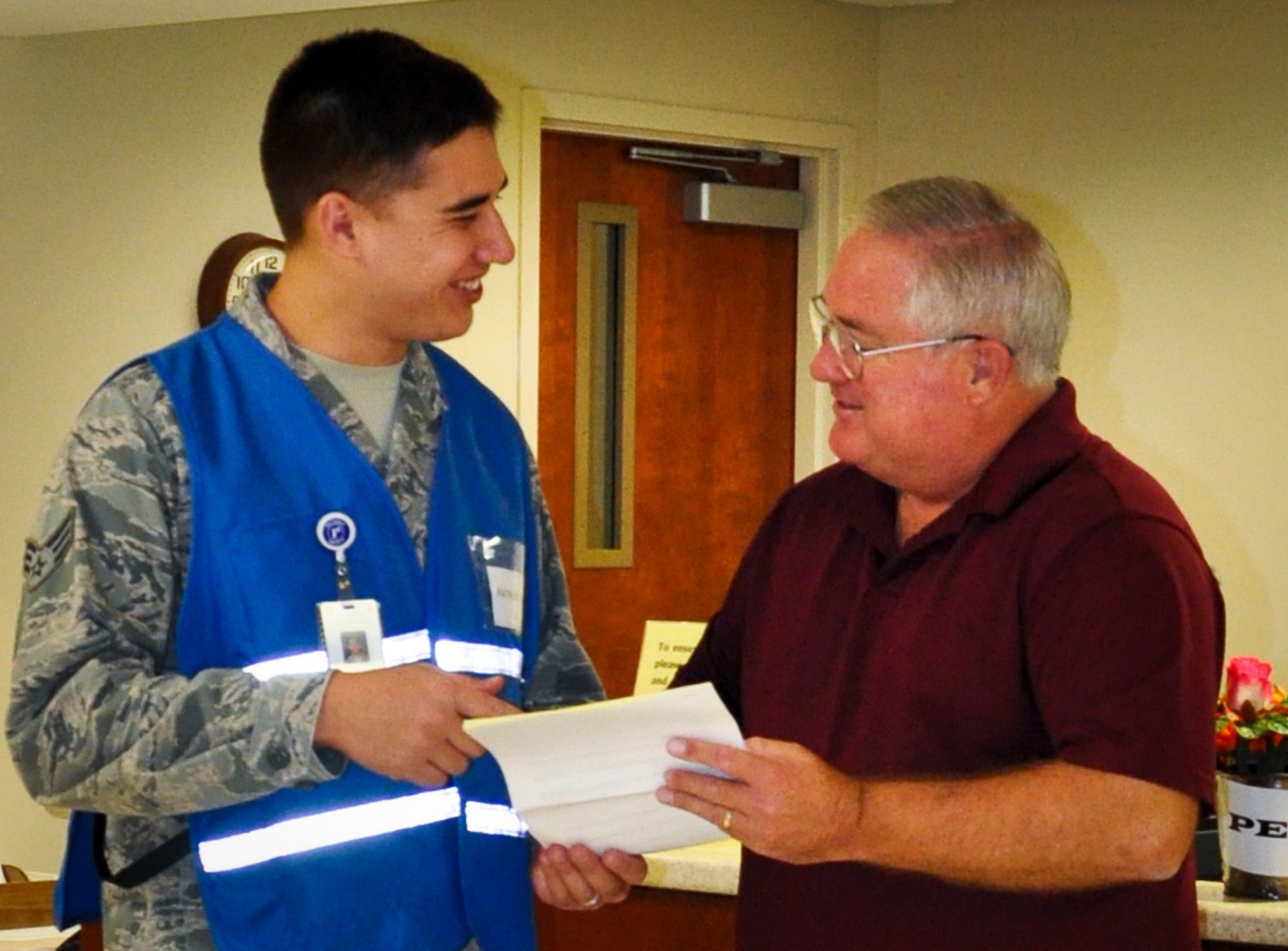 Senior Airman Austin Brunson, of the 96th Medical Group, escorts a visitor through the hallways of Eglin Hospital. Brunson is part of the new patient assistance program that was implemented at the hospital in March. People in need of assistance or directions should look for the Airmen in blue and red vests that are stationed throughout the hospital. (U.S. Air Force photo/Tech. Sgt. Crystal Turner)