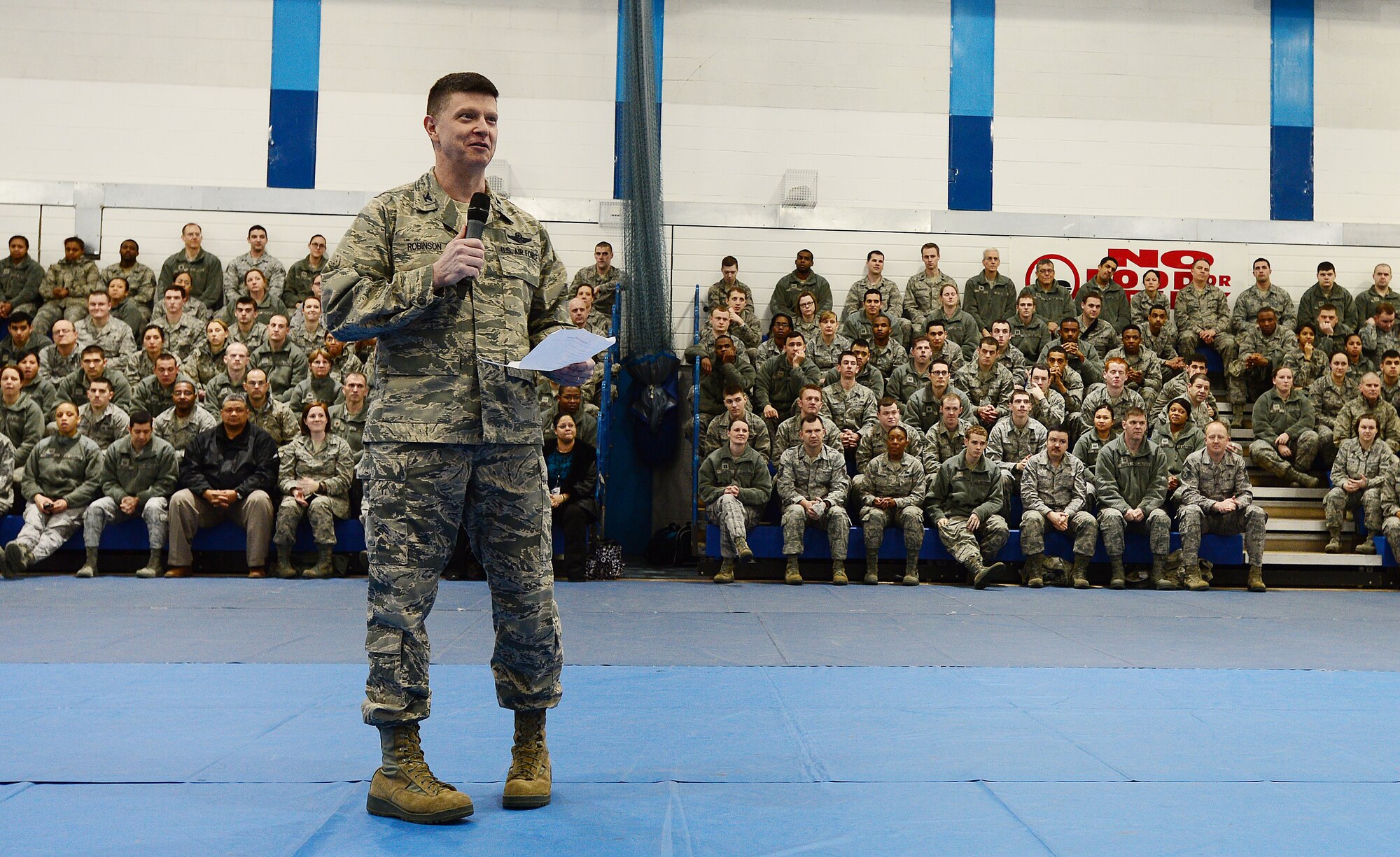 ROYAL AIR FORCE LAKENHEATH, England – Col. Kyle Robinson, 48th Fighter Wing commander, speaks to Liberty Airmen during a commander’s call at the base gym March 22, 2013. During the commander’s call, Robinson congratulated Airmen on their recent Air Force level awards, talked about upcoming exercises and held a questions and answer session.  (U.S. Air Force photo by Senior Airman Tiffany M. Grigg)